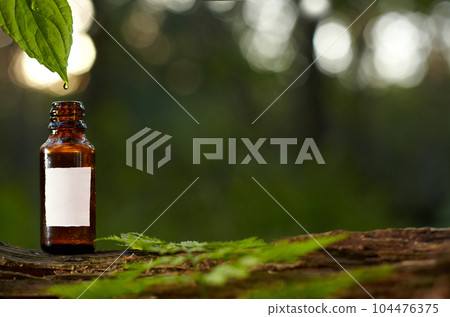 Natural cosmetic, medical product. White bottle in a natural environment, blurred background, mockup. 104476375