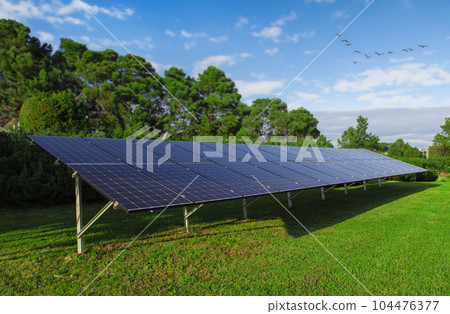 Solar panels against the background of greenery, nature. Clean energy concept. 104476377