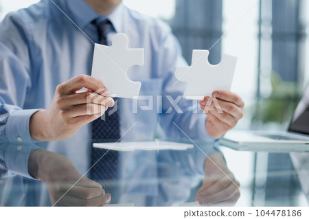 optimistic businessman holding a puzzle piece, solving problems, optimistic businessman holding a puzzle piece, solving problems, 104478186