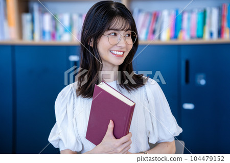 Middle-aged woman with a book Middle-aged woman with a book 104479152