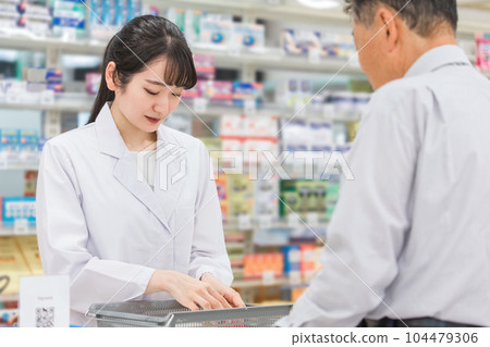 An elderly man and a pharmacist / pharmacist woman who receive medicine consultation at a pharmacy An elderly man and a pharmacist / pharmacist woman who receive medicine consultation at a pharmacy 104479306