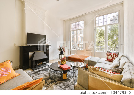 a living room with two couches and a flat screen tv in the corner of the room is very white 104479360