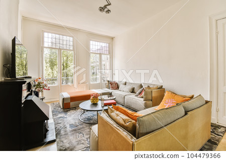 a living room with two couches, a coffee table and a flat screen tv in the wall is white a living room with two couches, a coffee table and a flat screen tv in the wall is white 104479366