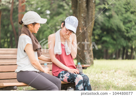 Asian woman in sportswear who is troubled by nausea and dizziness during exercise Asian woman in sportswear who is troubled by nausea and dizziness during exercise 104480077