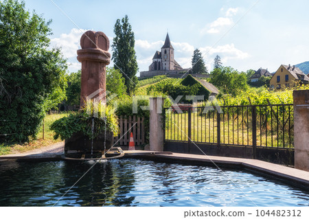 hunawihr old fountain and church 104482312