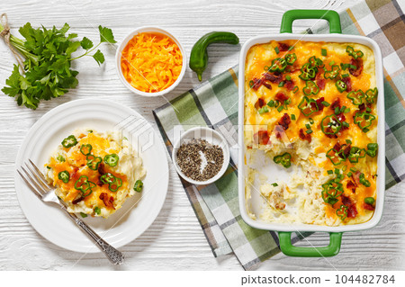 Loaded smashed potatoes with cheese, bacon, cream 104482784