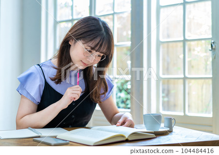 A young woman studying A young woman studying 104484416