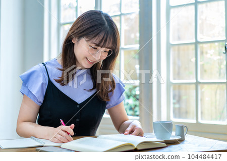 A young woman studying A young woman studying 104484417