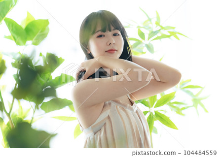 Woman surrounded by greenery Botanical image of beauty Woman surrounded by greenery Botanical image of beauty 104484559