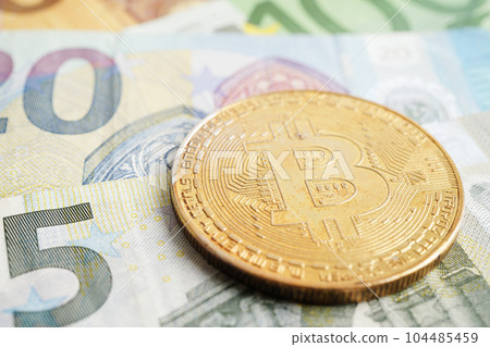 Golden bitcoin on Euro banknotes money for business and commercial, Digital currency, Virtual cryptocurrency. Golden bitcoin on Euro banknotes money for business and commercial, Digital currency, Virtual cryptocurrency. 104485459