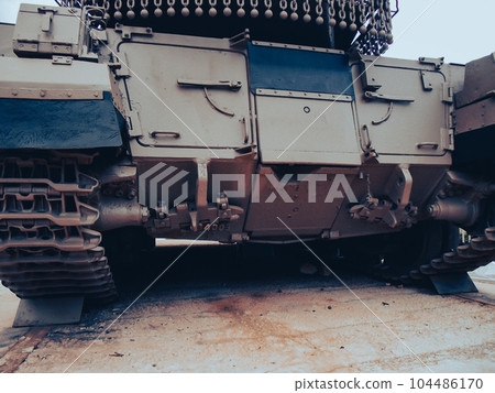 Ultra close-up of the caterpillar track of stationary war tank in an undisclosed location Ultra close-up of the caterpillar track of stationary war tank in an undisclosed location 104486170