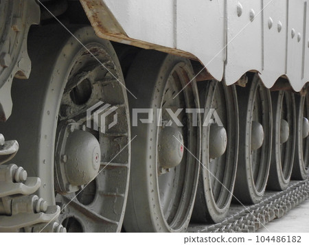 Ultra close-up of the caterpillar track of stationary war tank in an undisclosed location 104486182