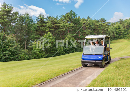 Golfer man and woman riding a golf cart on a golf course Golfer man and woman riding a golf cart on a golf course 104486201