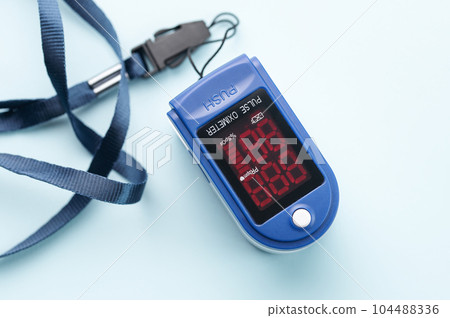 Pulse oximeter on blue background 104488336