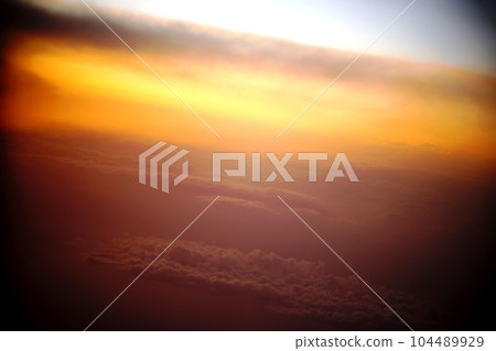 Sea of clouds and sunset from the window of the plane Sea of clouds and sunset from the window of the plane 104489929