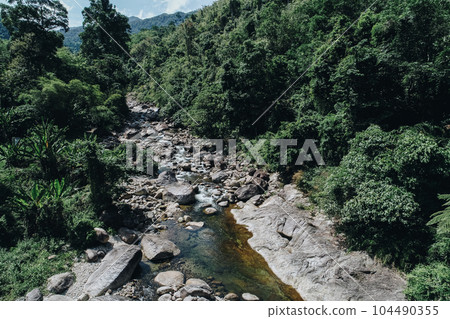 Beautiful waterfall in deep tropical rain forest nature landscape 104490355