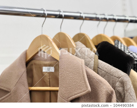 Close-up of coat collars lined up in a closet Close-up of coat collars lined up in a closet 104490384