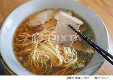 A classic bowl of Chinese noodles with soy sauce-based broth. A classic bowl of Chinese noodles with soy sauce-based broth. 104490760