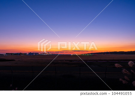 Beautiful sunset sky and panoramic airport scenery (Aso Kumamoto Airport) 104491055