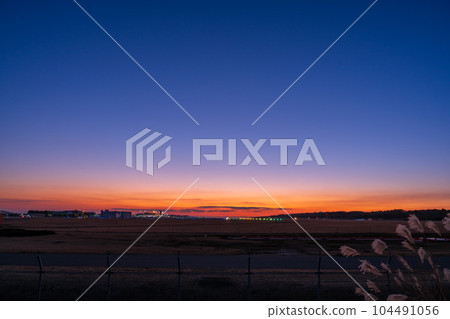 Beautiful sunset sky and panoramic airport scenery (Aso Kumamoto Airport) 104491056