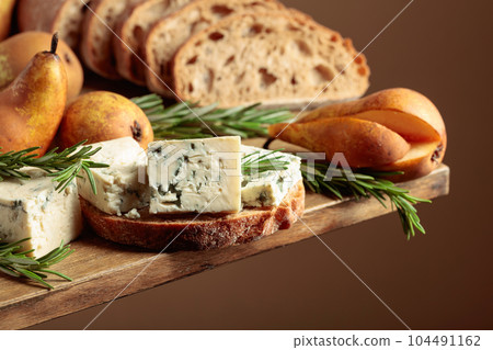 Blue cheese, pears, and rosemary. Blue cheese, pears, and rosemary. 104491162