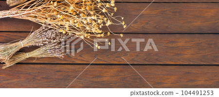 Bunches of dried herbs on wooden background banner Bunches of dried herbs on wooden background banner 104491253