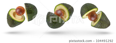Small set of flying avocados divided into parts isolated on white background. Avocados with pits are cut into pieces that fall in different directions. Avocado slices with peel on a white background. 104491292