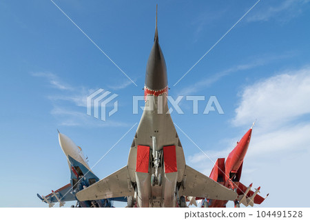 combat aircraft fighter bomber on a blue sky background 104491528