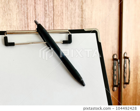 A pen and a closet in a clipboard 104492428