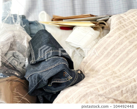 Paper bags, clothes and cloth piled up Paper bags, clothes and cloth piled up 104492448