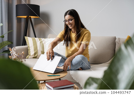 Getting to work. Enthusiastic young woman student opening the lid of laptop ready to start new classes Getting to work. Enthusiastic young woman student opening the lid of laptop ready to start new classes 104493747
