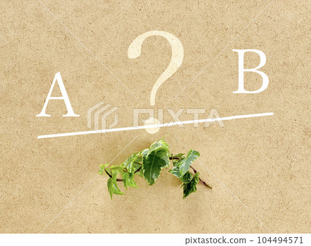 Letters A and B to be weighed _ board and ivy background 104494571