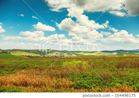 Beautiful landscape, spring nature. Landscape with mountains and valley in sunny day. View from above of sunny fields on rolling hills in Tuscany, Italy 104496175