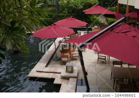 restaurant balcony table with red parasol near the pool by top view 104496601