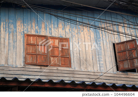 Wooden window of old Thai house with wire cable 104496604