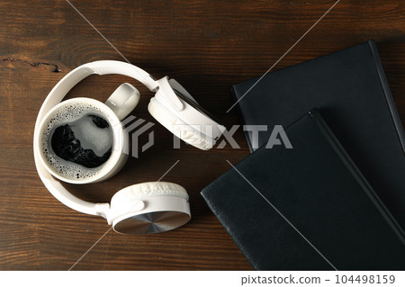 Concept of freelance, composition with hot drink and headphones Concept of freelance, composition with hot drink and headphones 104498159