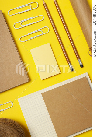 Mockup flat lay with different office accessories on yellow background Mockup flat lay with different office accessories on yellow background 104499370
