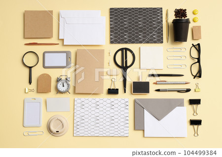 Mockup flat lay with different office accessories on beige background 104499384