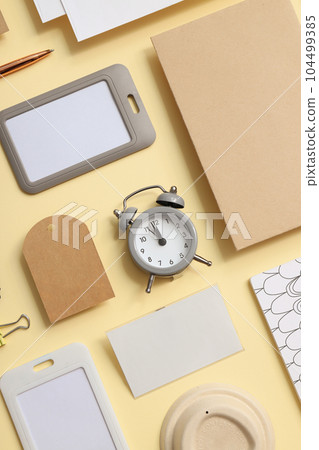 Mockup flat lay with different office accessories on beige background 104499385