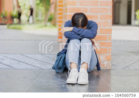 Teen girl sad cry from fail exam. University Student tired sitting down sleep or mental sick 104500759