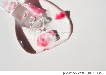 Pipette and drop of cosmetic product with rose petals, selective focus Pipette and drop of cosmetic product with rose petals, selective focus 104501353