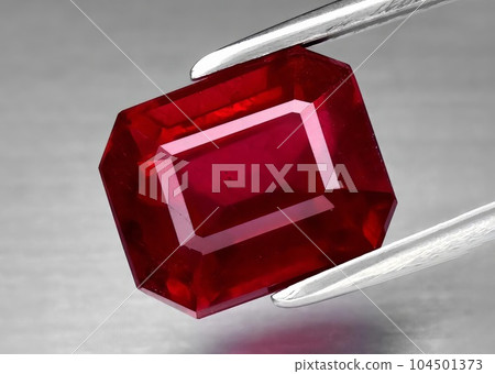 Natural gemstone red ruby on gray background Natural gemstone red ruby on gray background 104501373