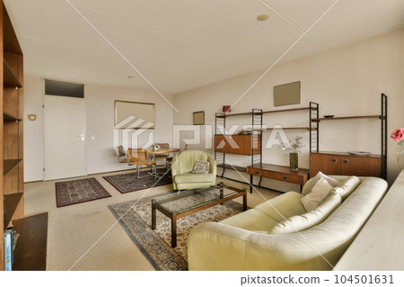 a living room with two couches and a coffee table in the center of the room is an office area a living room with two couches and a coffee table in the center of the room is an office area 104501631