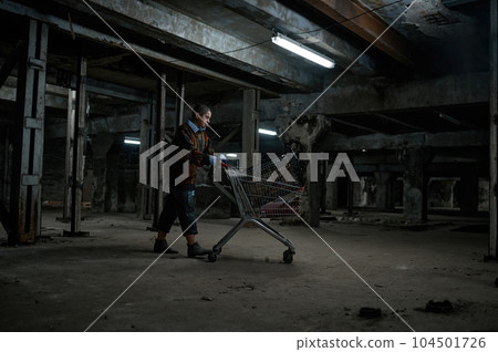 Drunk young homeless woman pushing shopping trolley cart Drunk young homeless woman pushing shopping trolley cart 104501726