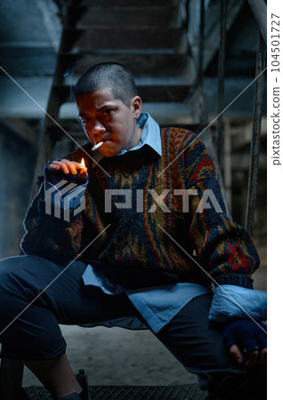 Lonely helpless unemployed teenager girl lighting cigarette Lonely helpless unemployed teenager girl lighting cigarette 104501727