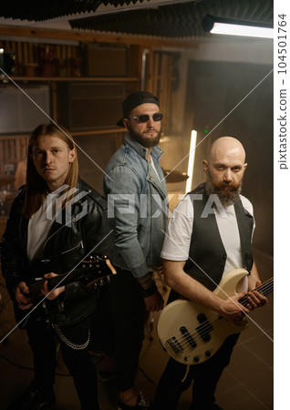 Rock band portrait with rockstar guitar player of different age 104501764