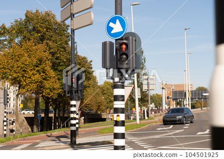Traffic light-regulated intersection with road signs. Red traffic light Traffic light-regulated intersection with road signs. Red traffic light 104501925