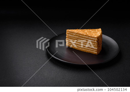 Delicious fresh sweet honey cake layer cake with white cream Delicious fresh sweet honey cake layer cake with white cream 104502134