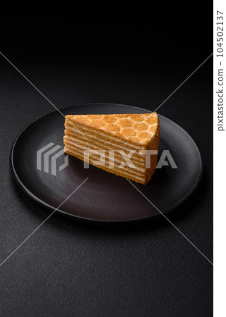 Delicious fresh sweet honey cake layer cake with white cream 104502137