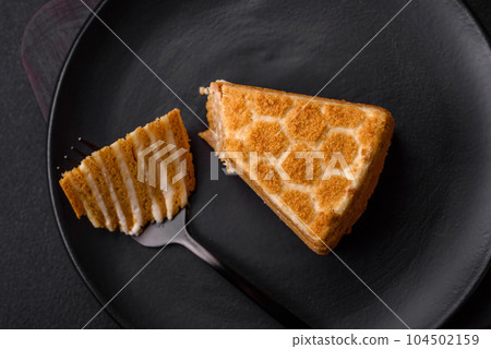 Delicious fresh sweet honey cake layer cake with white cream 104502159